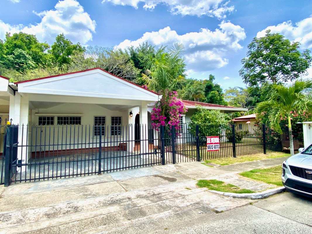 Front exterior with covered carport, fencing, yard Albrook Panama city house for sale