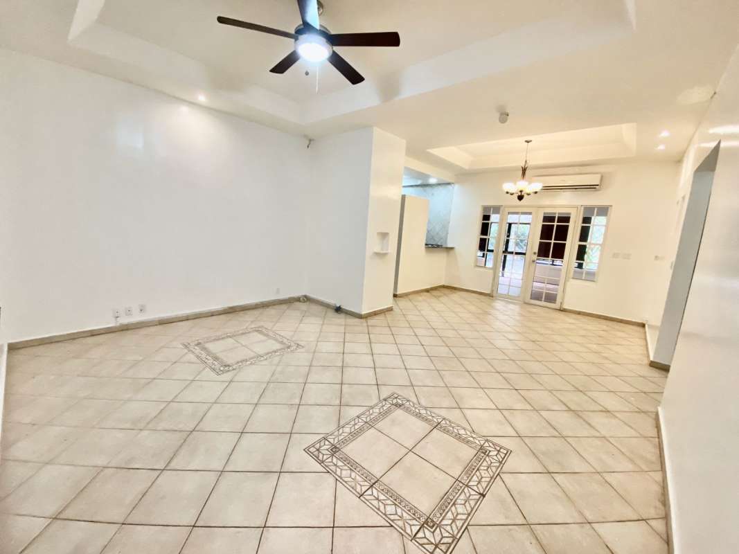 Spacious bedroom with tile floor, ceiling fan, air conditioning and windows in house for sale Albrook Panama