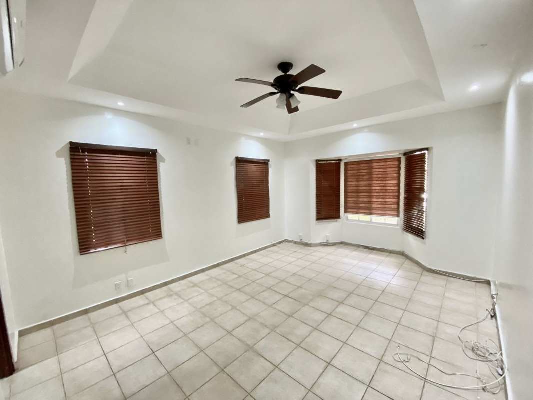 Living room with tile floor, tray ceiling, ceiling fan, wooden blinds Albrook Panama