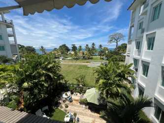 Balcony overlooking gardens, palm trees, Pacific Ocean at Bijao Resort Panama