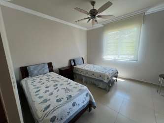 Living room with sectional sofa, TV, large windows in PH Bijao Balboa II Panama