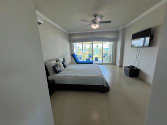 Bedroom with glass sliding doors to balcony, flat TV, AC at PH Bijao Balboa II Panama