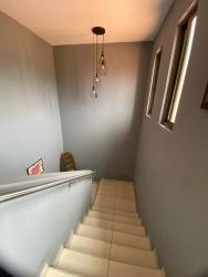 Bedroom with large window, ceiling fan, light blue walls and tiled floor in PH Woodland Panama
