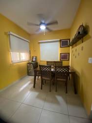 Dining area with ceiling fan, tile floor, yellow walls, and wooden dining set in Panama Pacifico home