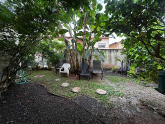Covered patio overlooking lush backyard garden in PH Woodland Panama Pacifico