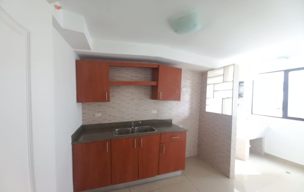 Modern kitchen with granite look countertop, wooden cabinets, large window in PH San Francisco Bay Tower 500 Panama City