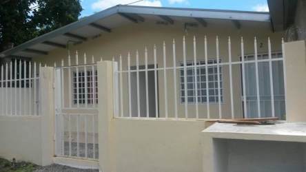 Entryway with metal security door, window bars, tiled floor studio apartment David Chiriquí Panama