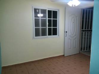 Bathroom with ceramic sink, toilet, tiled walk-in shower in affordable studio in David Chiriquí Panama