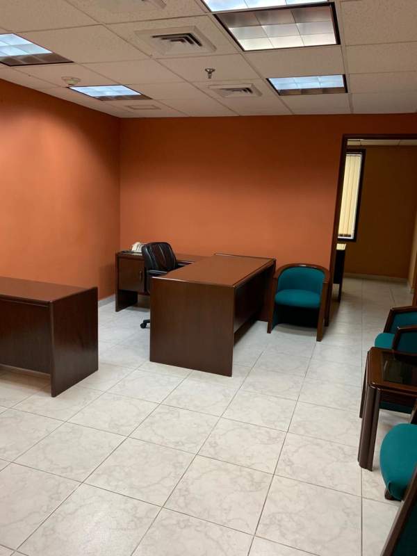 Interior offices furnished with desks chairs shelving PH Century Tower Marbella Panama