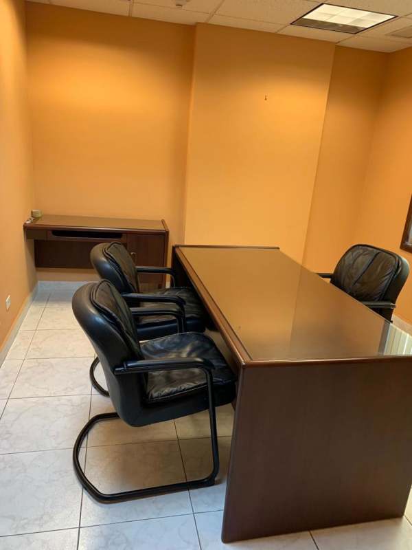 Small corporate office with wooden desk chairs and cabinet PH Century Tower Marbella Panama