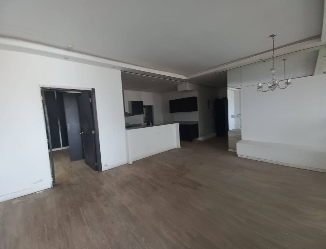 Bright living room with city views, wood flooring, and balcony access PH Quadrat San Francisco