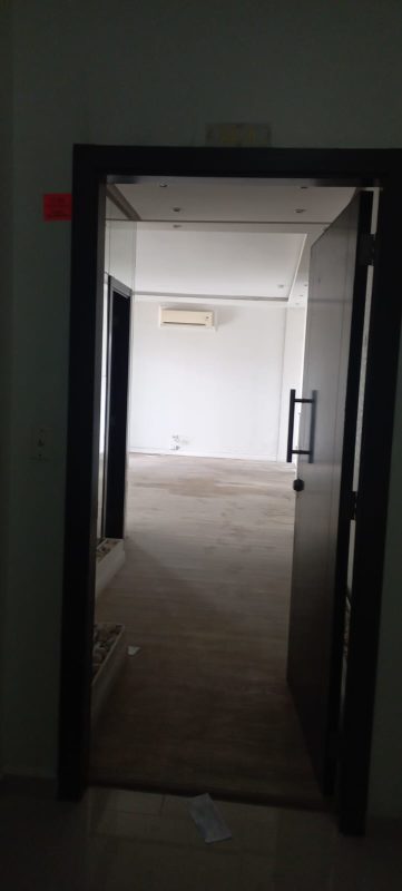 Large walk-in closet with built-in shelves and city view window at PH Quadrat apartment in San Francisco Panama