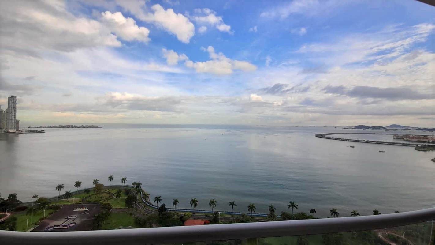 Modern living area with floor-to-ceiling windows panoramic ocean and city views PH Rivage Panama