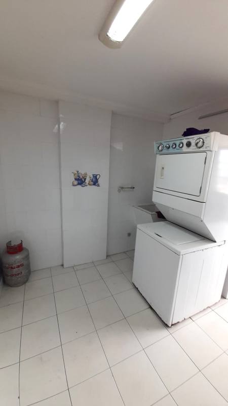 Laundry area with stacked washer dryer, tiled finish and utilities PH Monterrey Panama City