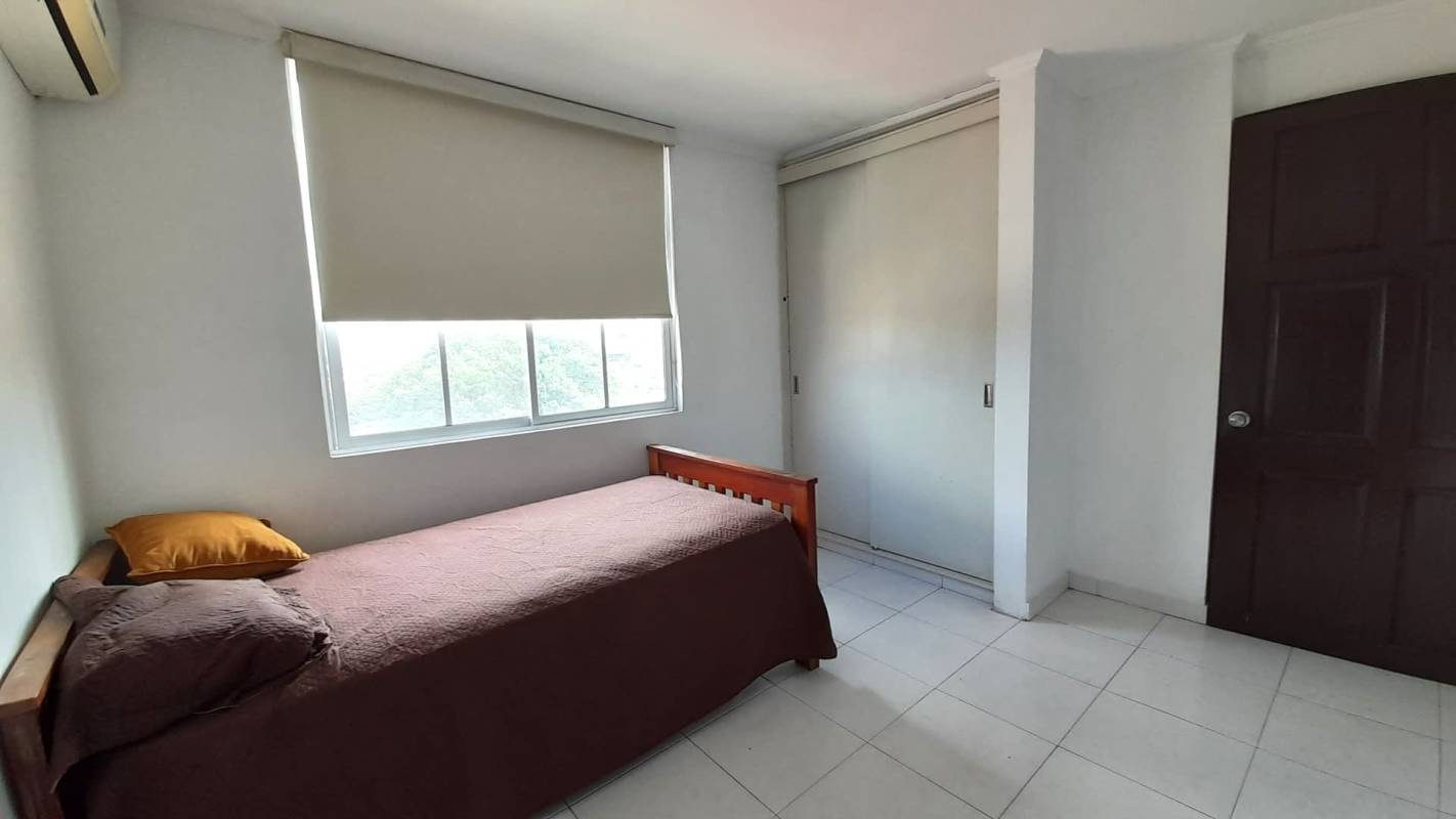 Minimalist bedroom with AC, closet, and view of La Loma neighborhood PH Monterrey