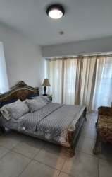 Open kitchen with island, stainless appliances and seating at Royal Palm beachfront apartment Panama