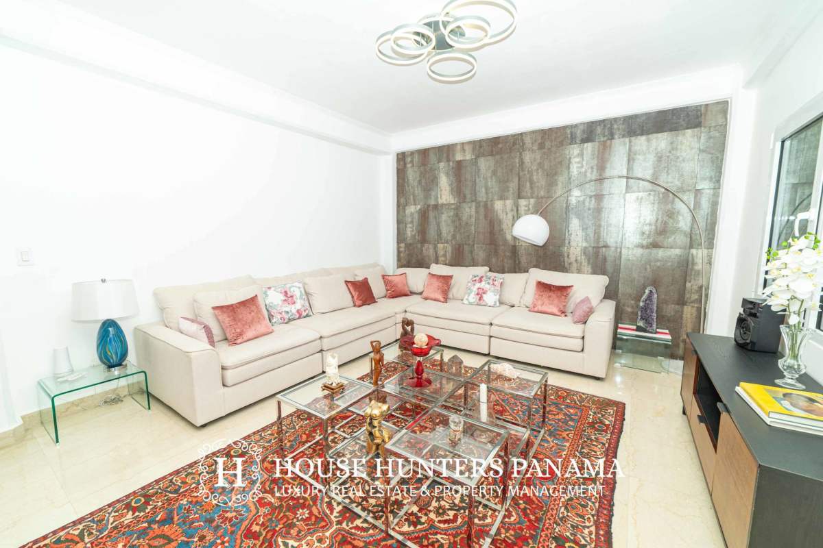 Spacious master bedroom with private balcony, stone accent wall and panoramic windows in luxury Albrook mansion