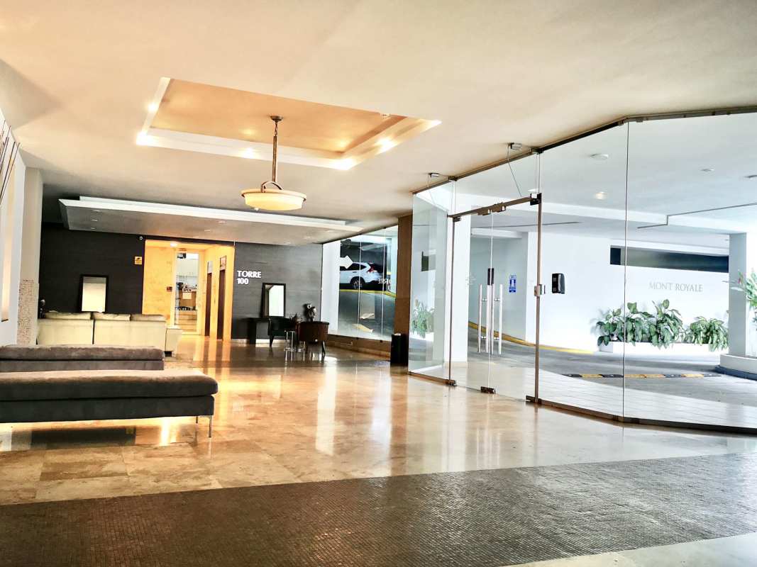 Lobby with glass entrance, seating, marble floor in PH Mont Royale Panama City