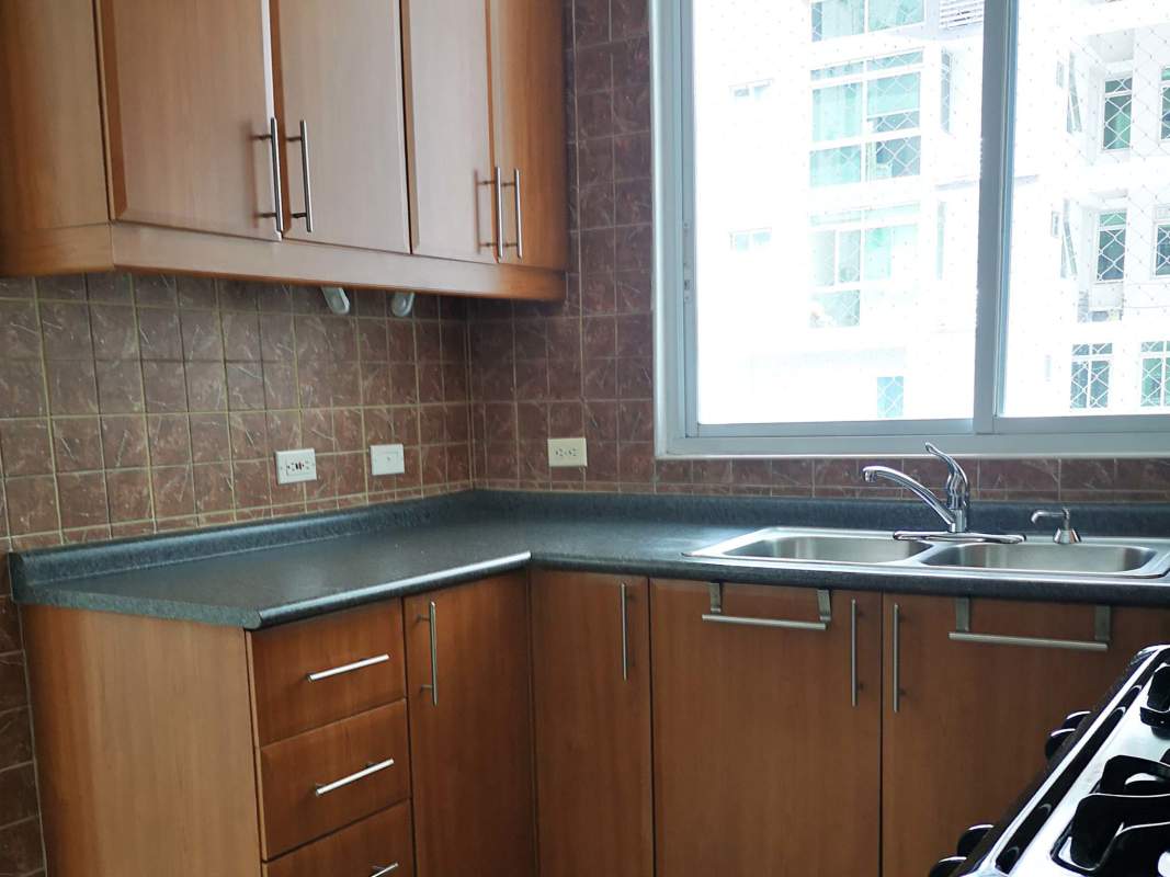 Modern kitchen with wood cabinetry and granite countertops PH Mont Royale Panama