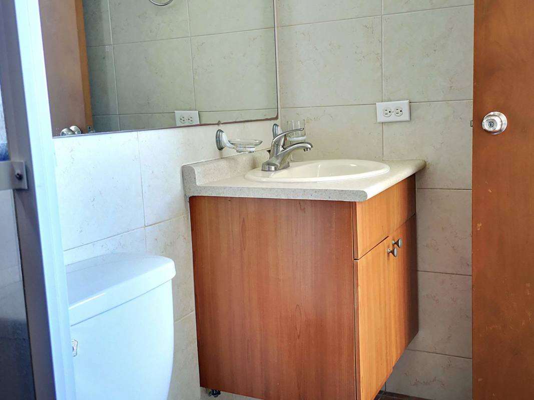 Bathroom with large mirror, vanity sink and wall tiles PH Mont Royale Panama