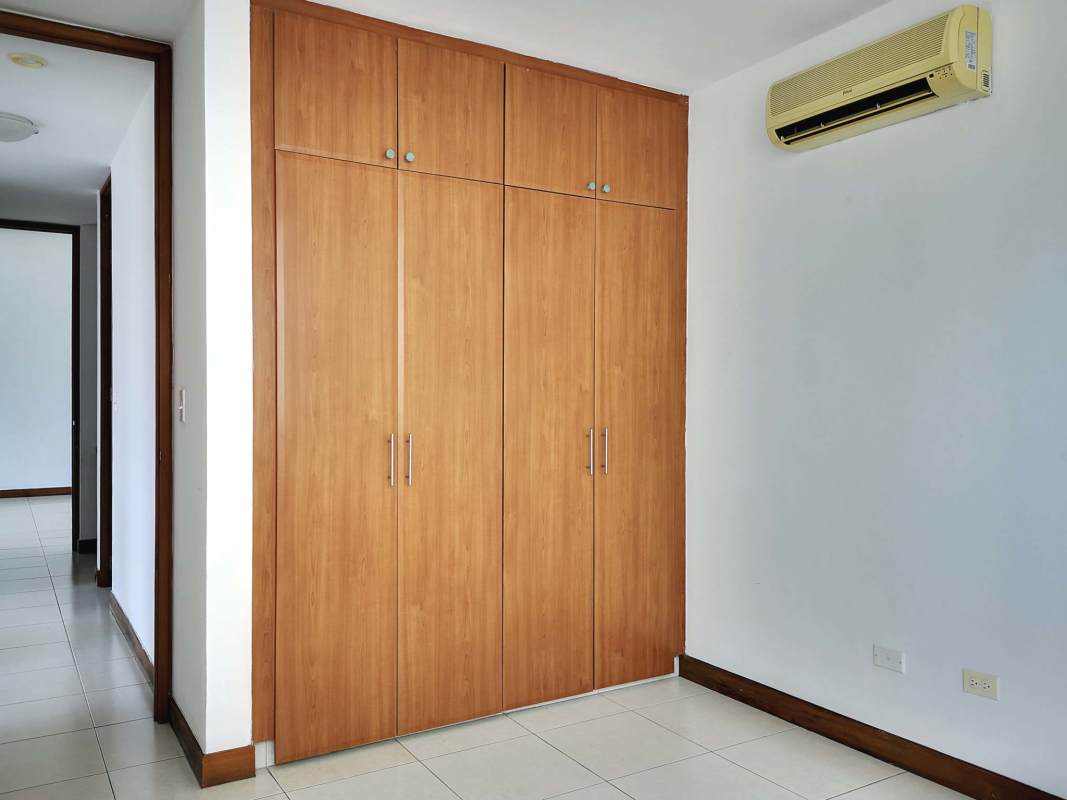 Bedroom with built-in wardrobe, AC unit and ceramic floor PH Mont Royale Panama apartment