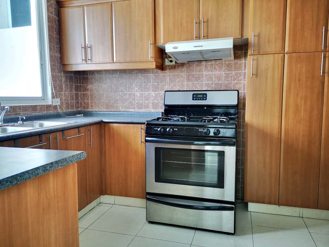 Wood cabinets, granite counters and window PH Mont Royale Panama apartment