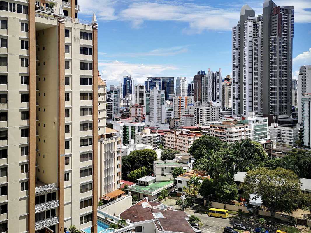 View of high-rise towers swimming pool and greenery PH Mont Royale Panama apartment complex