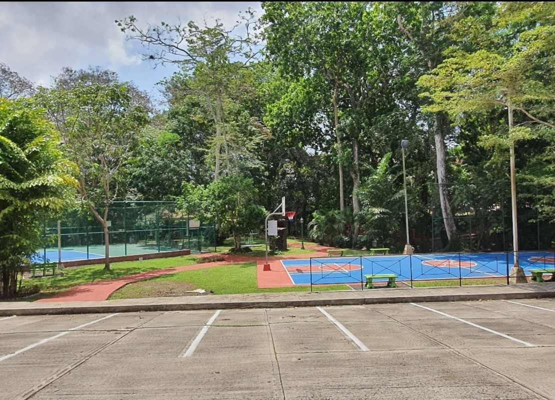 Outdoor tennis and basketball courts with landscaped surroundings in Camino de Cruces Clayton Panama City