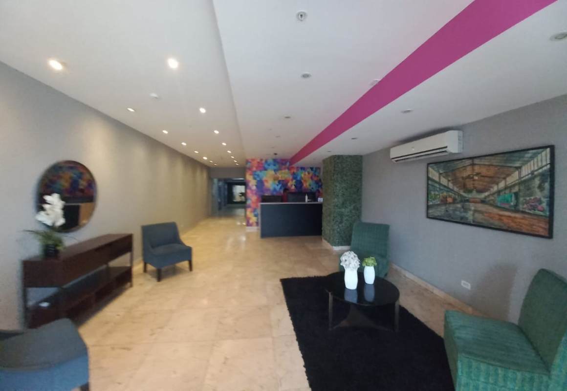 Modern lobby entrance with marble floor, reception desk, security in PH Rainbow Tower Panama City