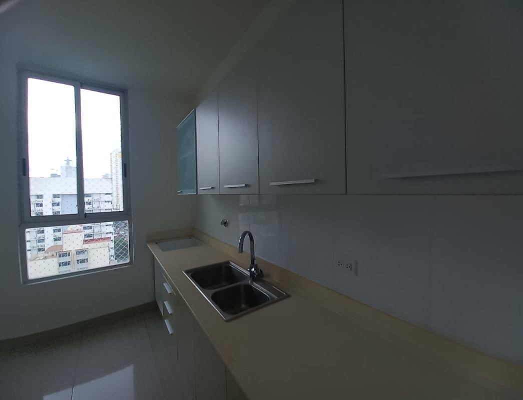 Spacious living area opens to balcony with city views, tiled floors, at PH Rainbow Tower Panama City