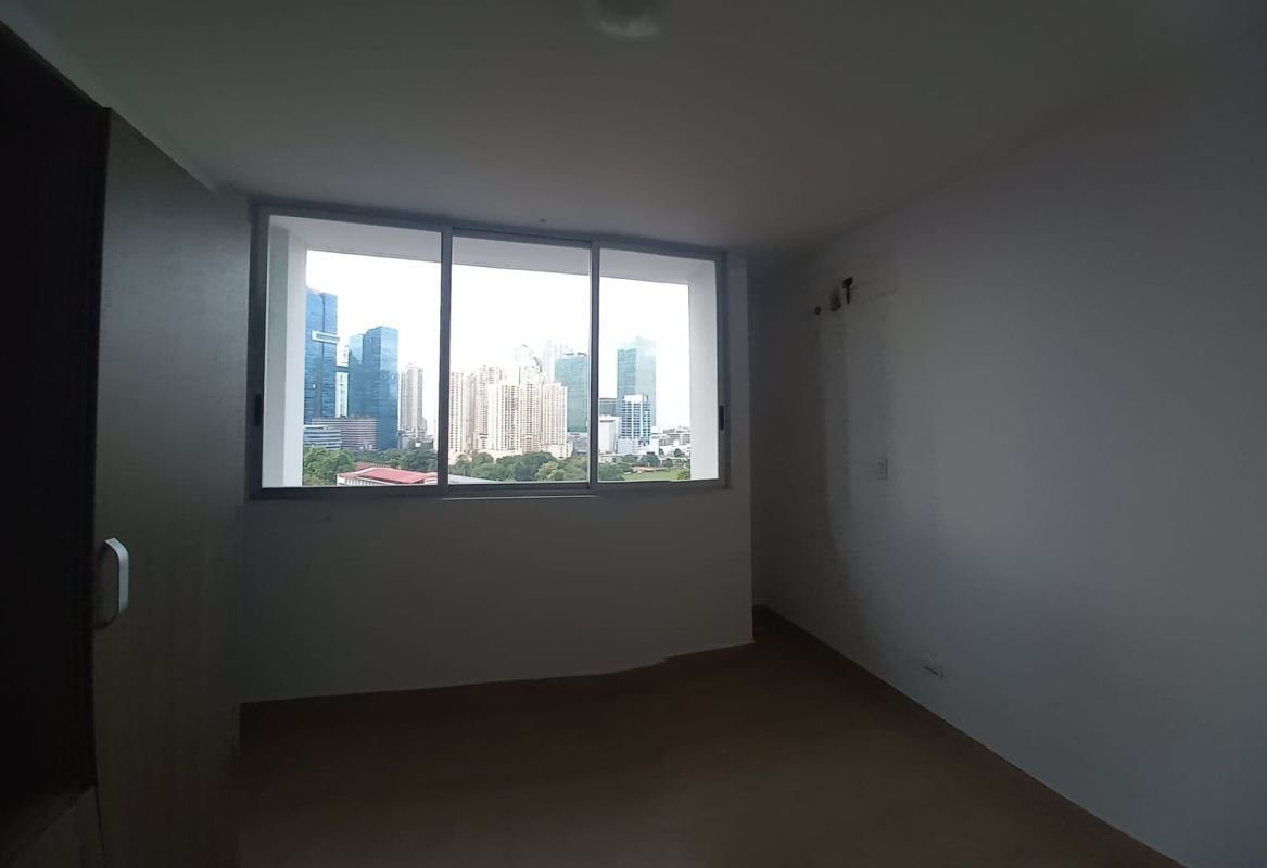 Bedroom with large window offering skyline views in PH The One Tower San Francisco Panama City