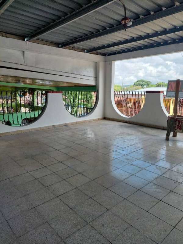 Spacious covered terrace with iron railings and tiled flooring affordable house Altos de Las Acacias Panama