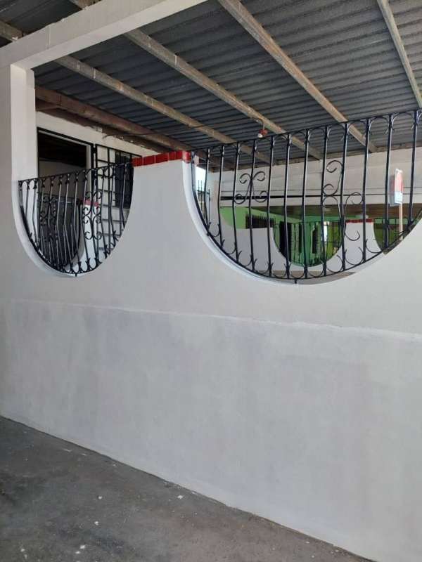 Decorative wrought iron window bars and covered area Panamanian affordable home