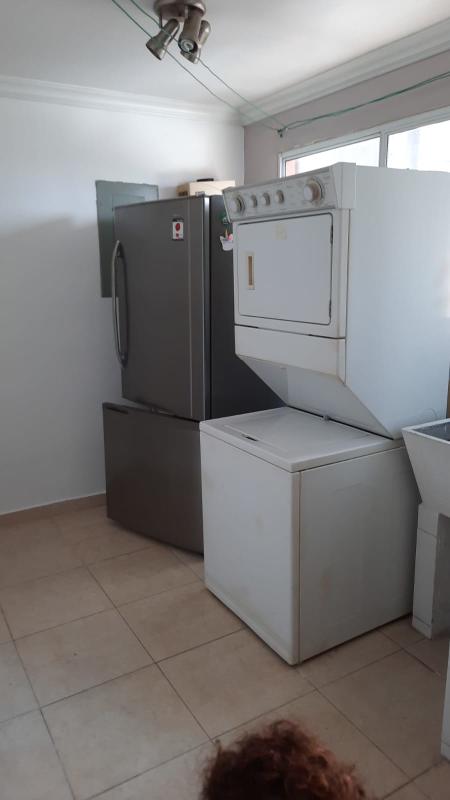 Laundry area with washer dryer utility sink refrigerator at PH Villa de las Fuentes Panama