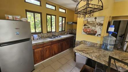 Rustic kitchen with wood cabinets granite countertops stainless appliances in mountain house in Altos del María