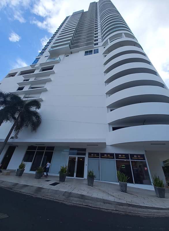 Modern high-rise facade PH Marina Plaza with retail shops parking in San Francisco Panama