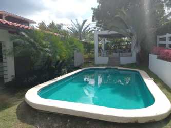 Private swimming pool with gazebo, tropical garden in Club Ecuestre Coronado beach house