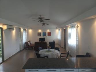 Large living room with natural light and modern furniture in Coronado Panama beach house