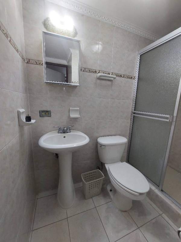 Tile-finished modern bathroom with walk-in shower, sink, large mirror in Albrook Tower Residence Panama