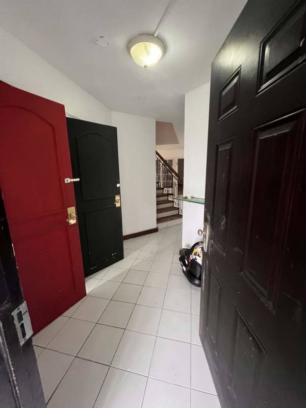 Entryway with tiled floor, decorative iron railing staircase in house Obarrio Panama City