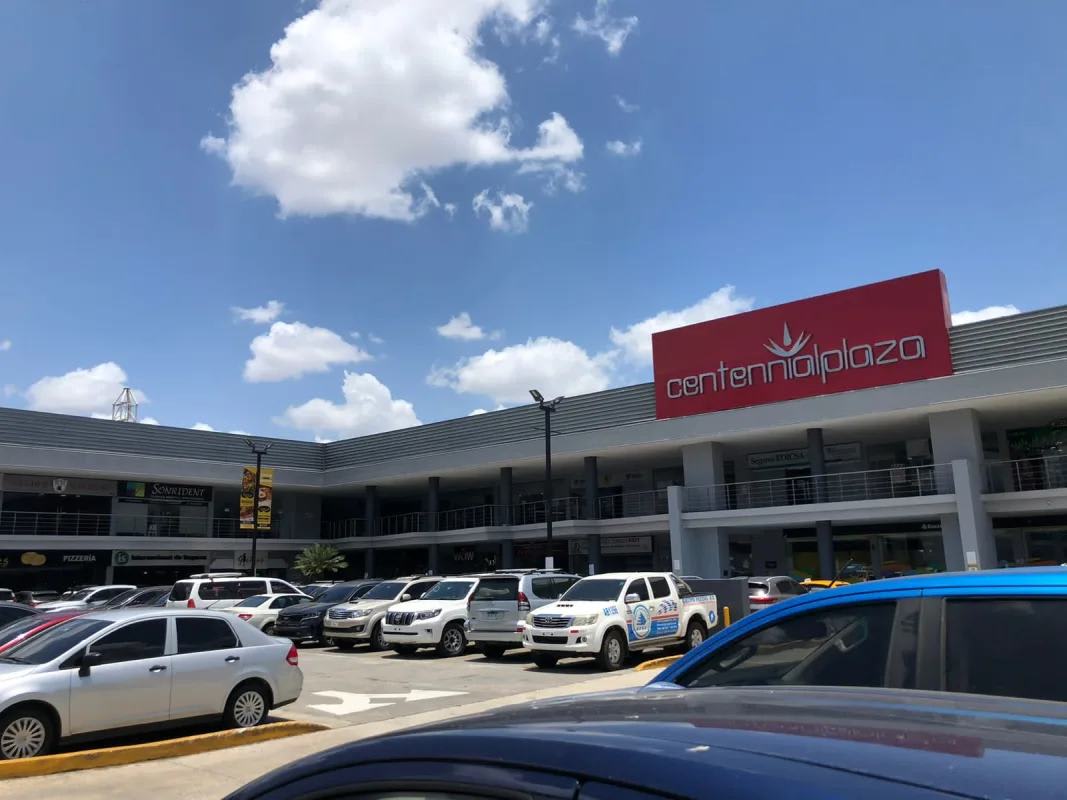Exterior view of Centennial Plaza with ample parking, storefronts, and signage in Condado del Rey Panama
