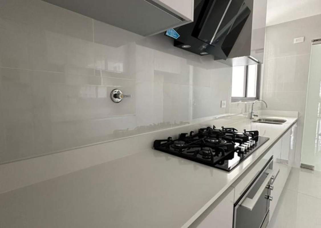 Modern kitchen with granite counters, gas stove and cabinetry at PH Velure El Cangrejo Panama