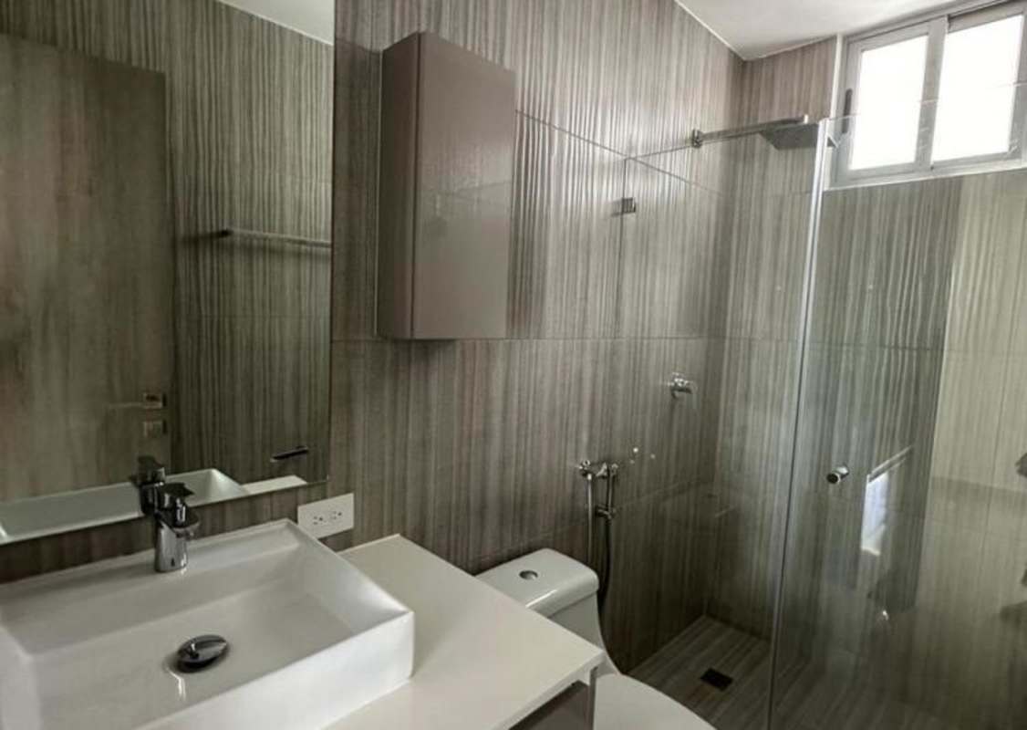 Bathroom with gray tiles, glass shower, large window PH Velure El Cangrejo Panama