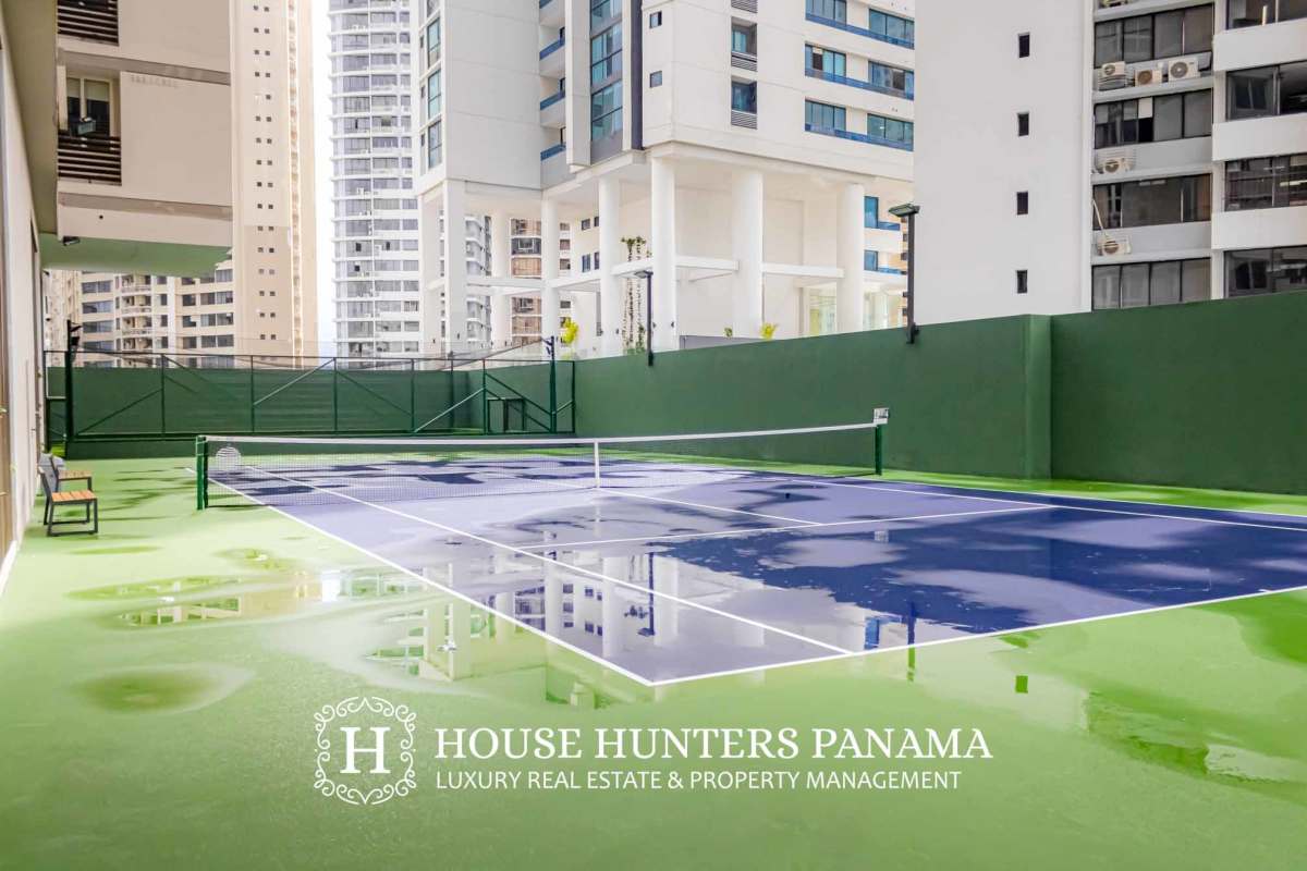 Spacious living room with floor-to-ceiling window ocean and skyline views Punta Paitilla Panama