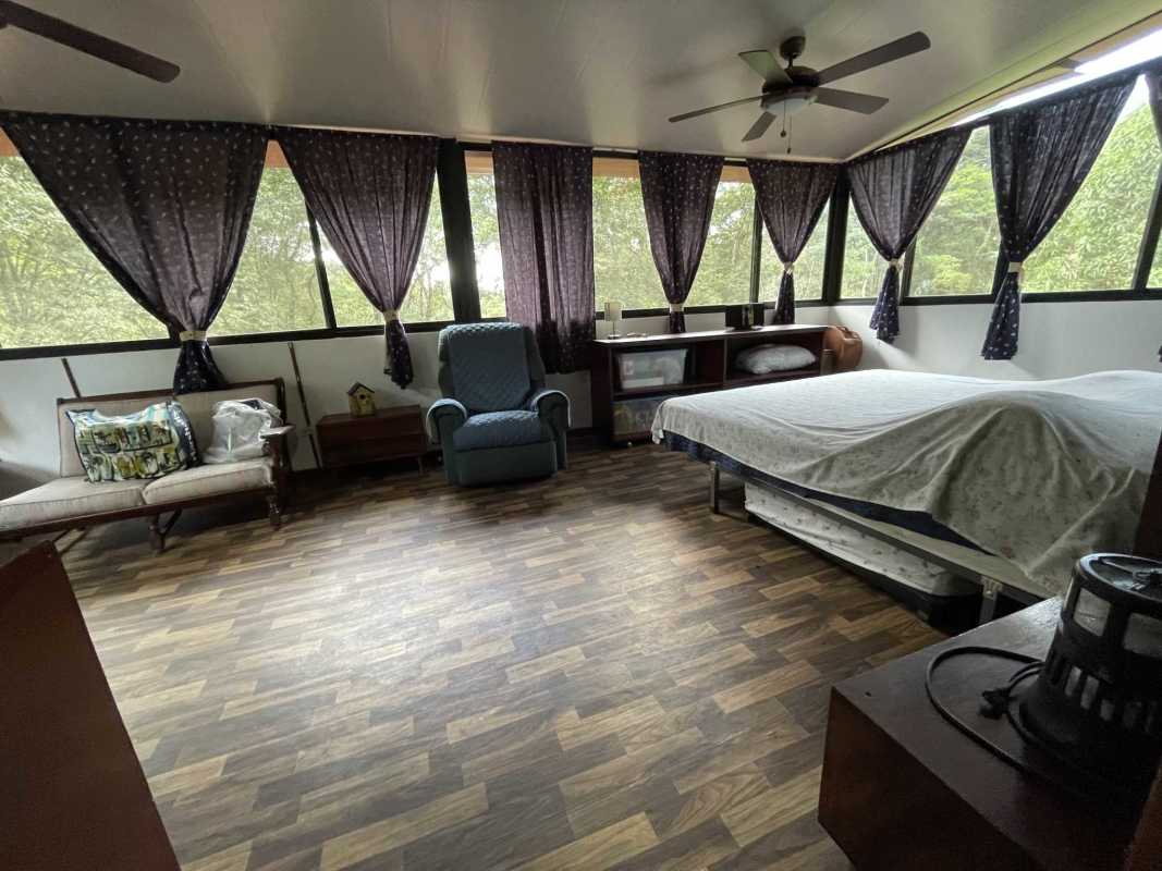 Rustic living room area with wooden ceiling beams and views to the mountain garden
