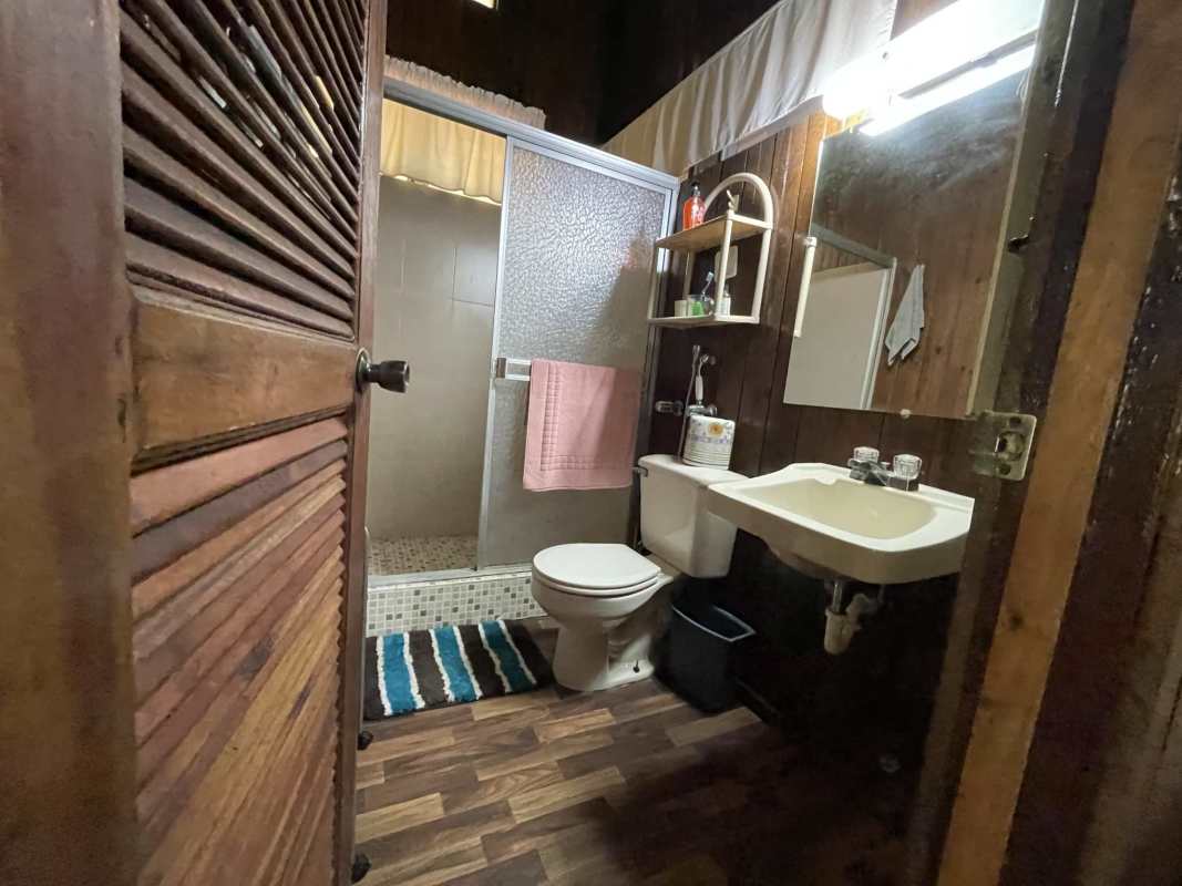 Rustic kitchen with wood cabinets and panoramic views of gardens in Cerro Azul country home