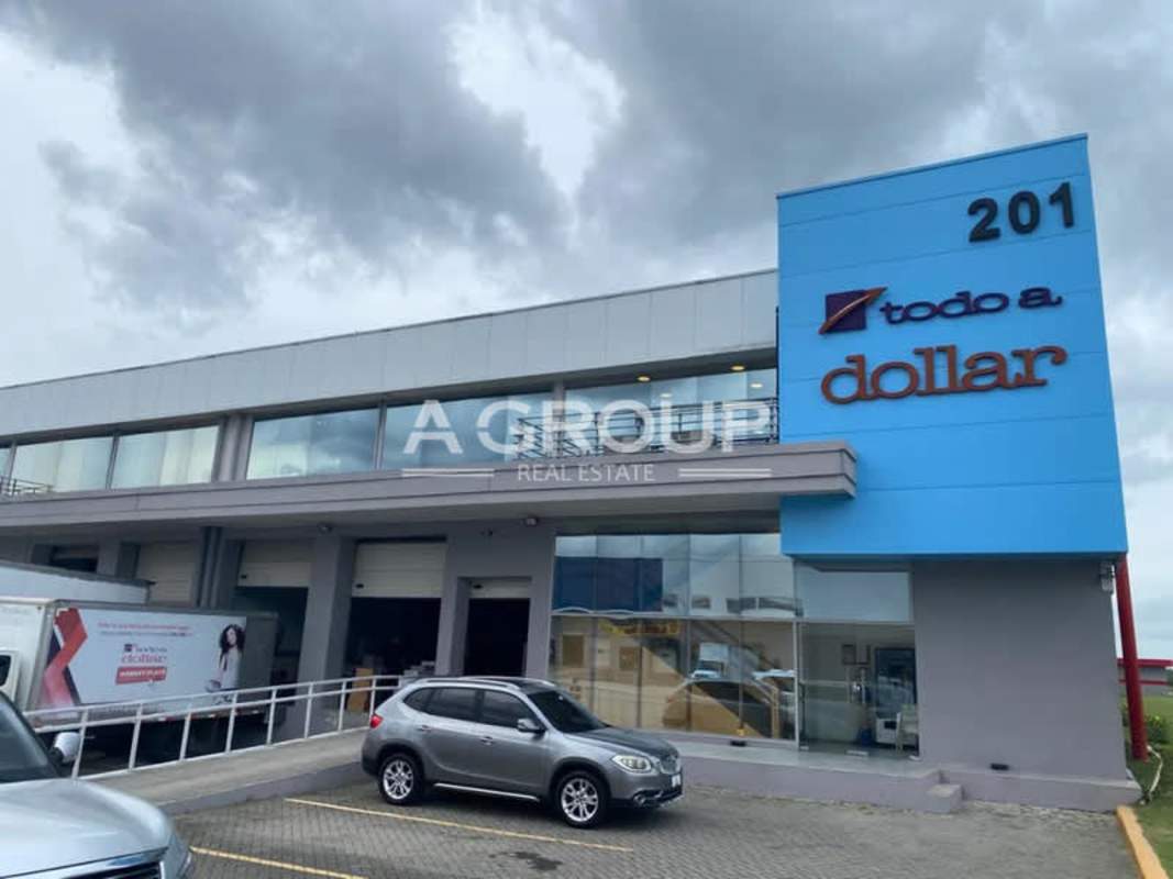 Small kitchenette with sink, microwave, shelves, foldable table in warehouse Panama