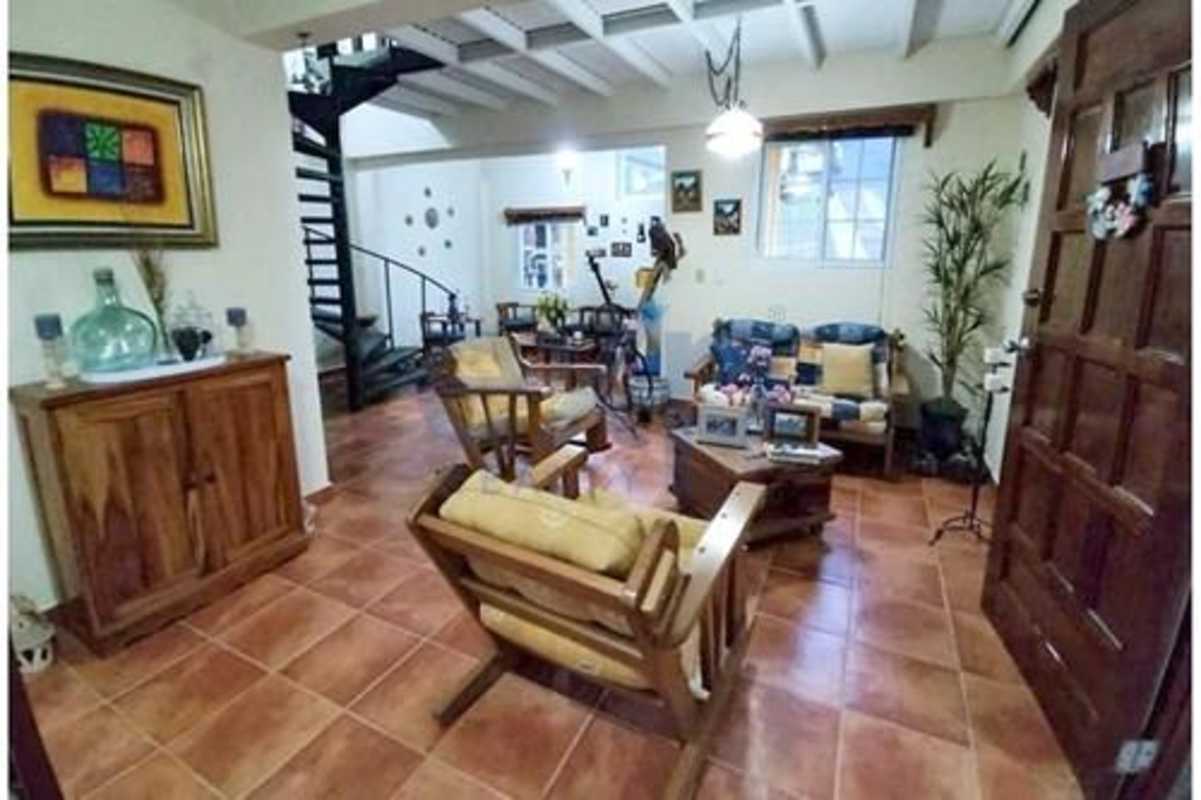Rustic living room with spiral staircase ceramic floors Panama Cerro Azul house