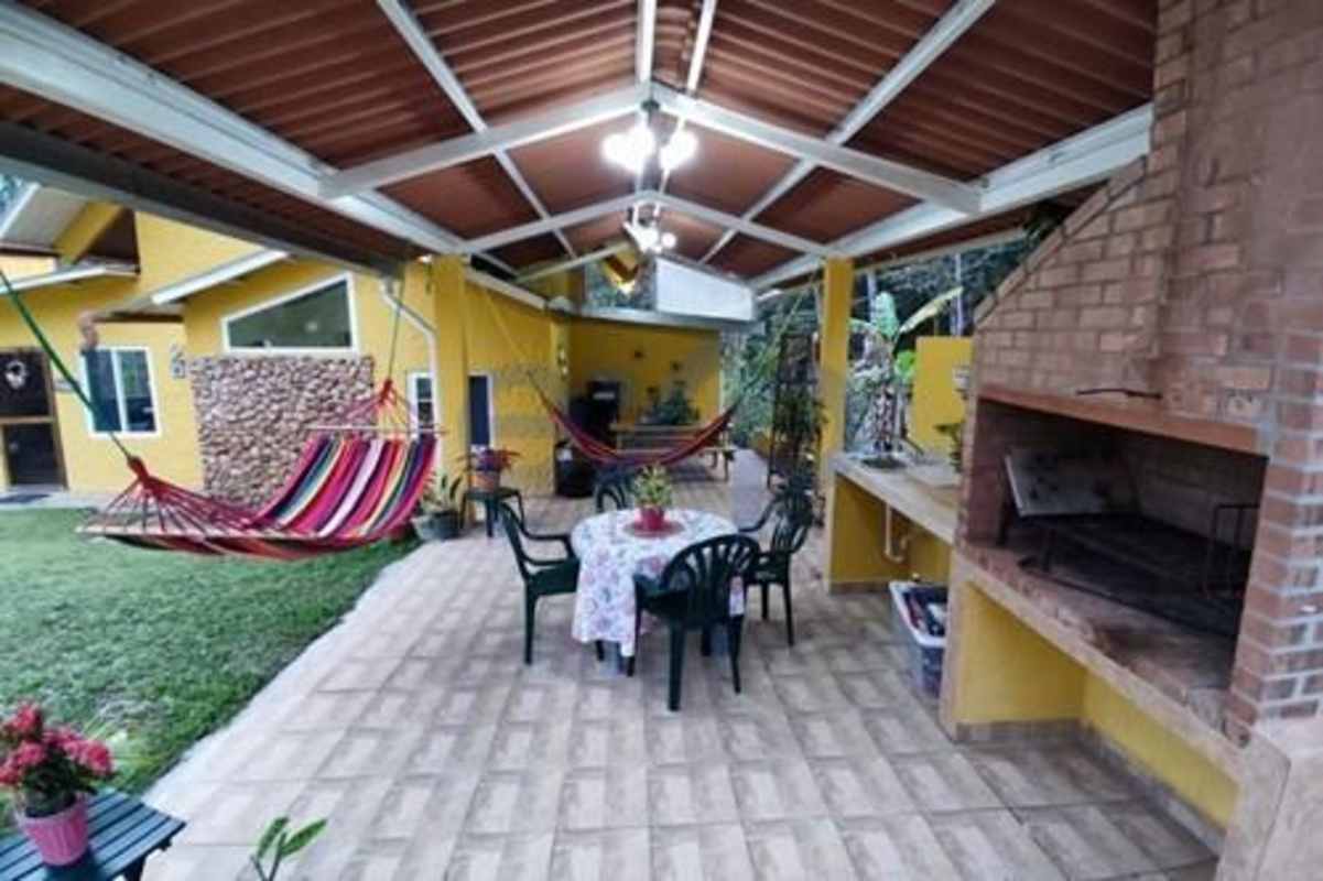 Modern bathroom with pedestal sink, mosaic tiles in Cerro Azul mountain house Panama