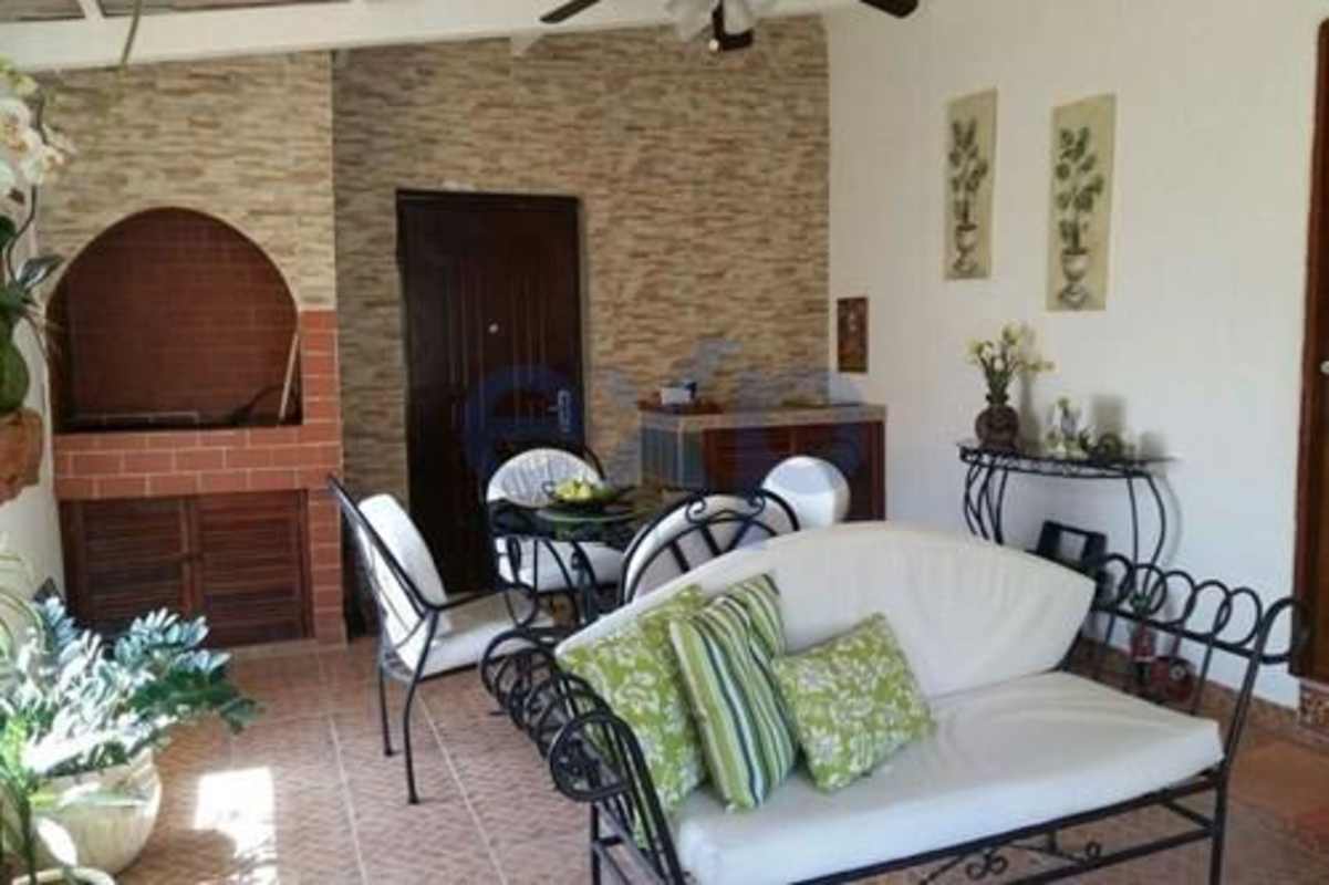Rustic family room with spiral staircase, wood beams, tile floors Cerro Azul Panama house